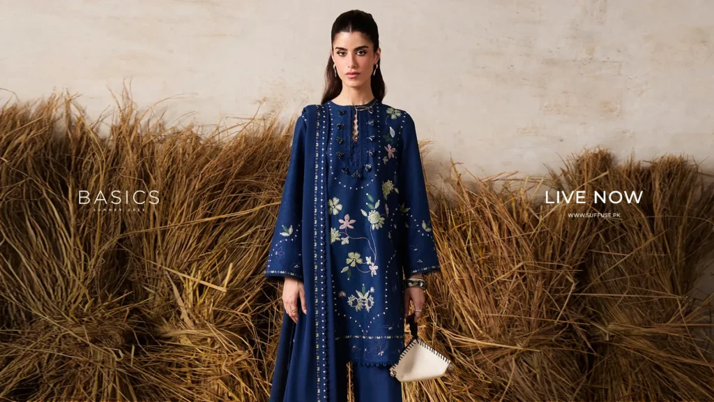 Close-up detail shot of intricate silver and pearl hand-embroidery on the sleeve of a luxurious silk Suffuse formal dress.