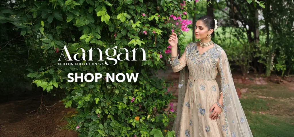 Mannequins dressed in vibrant Roheenaz outfits with artistic designs, showcased at the entrance of a chic boutique.