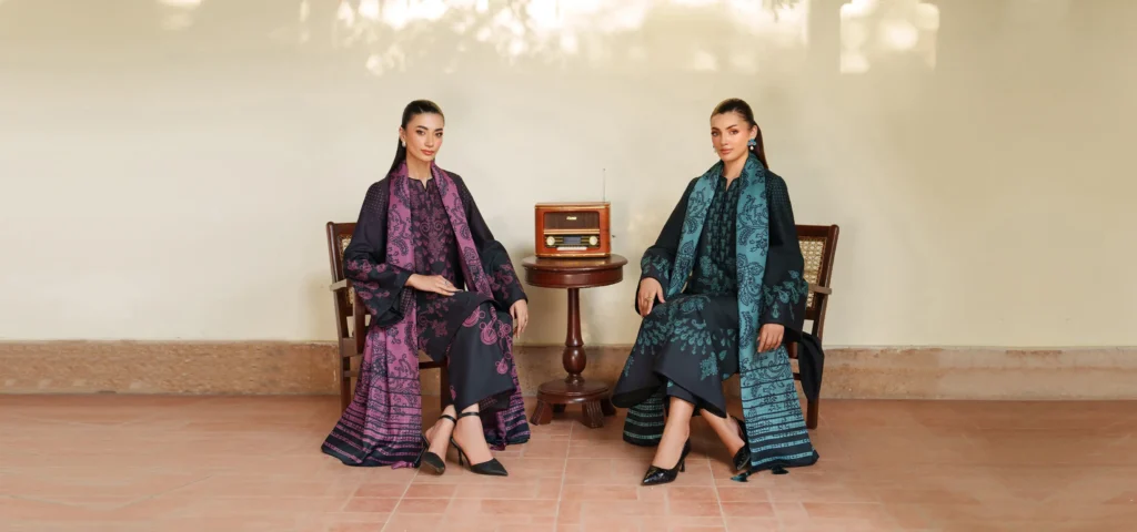 Mannequins dressed in ornate Jazmin festive outfits with rich embroidery, showcased at the entrance of an upscale boutique.