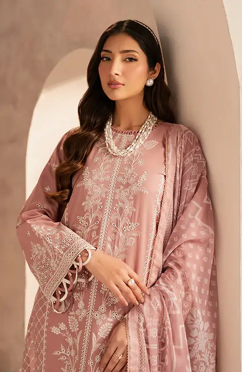 Shop assistants carefully arrange Zarif garments on racks, preparing the store for the launch of a new collection.