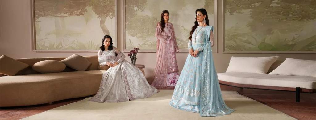 Mannequins in stylish Zarif outfits with intricate detailing stand at the entrance of a boutique.